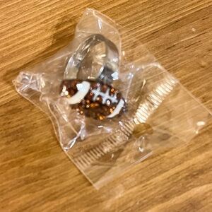 New in package football adjustable ring on silver tone with brown rhinestones 8
